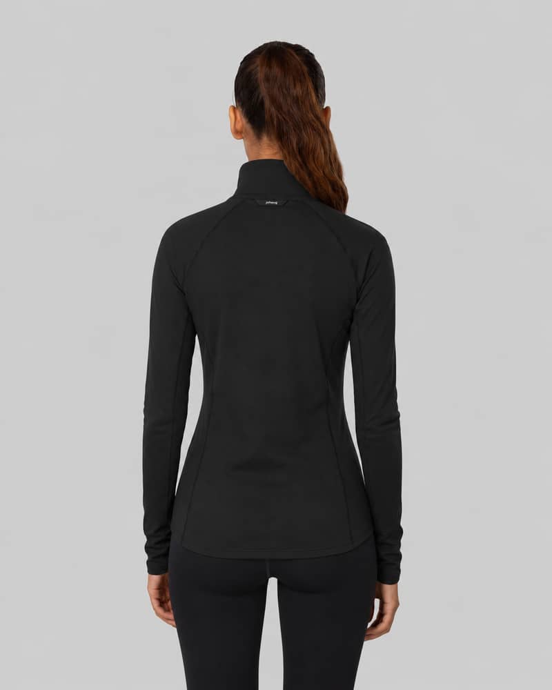 Woman wearing a black Johaug long-sleeve mock-neck top, rear view, against a light gray background