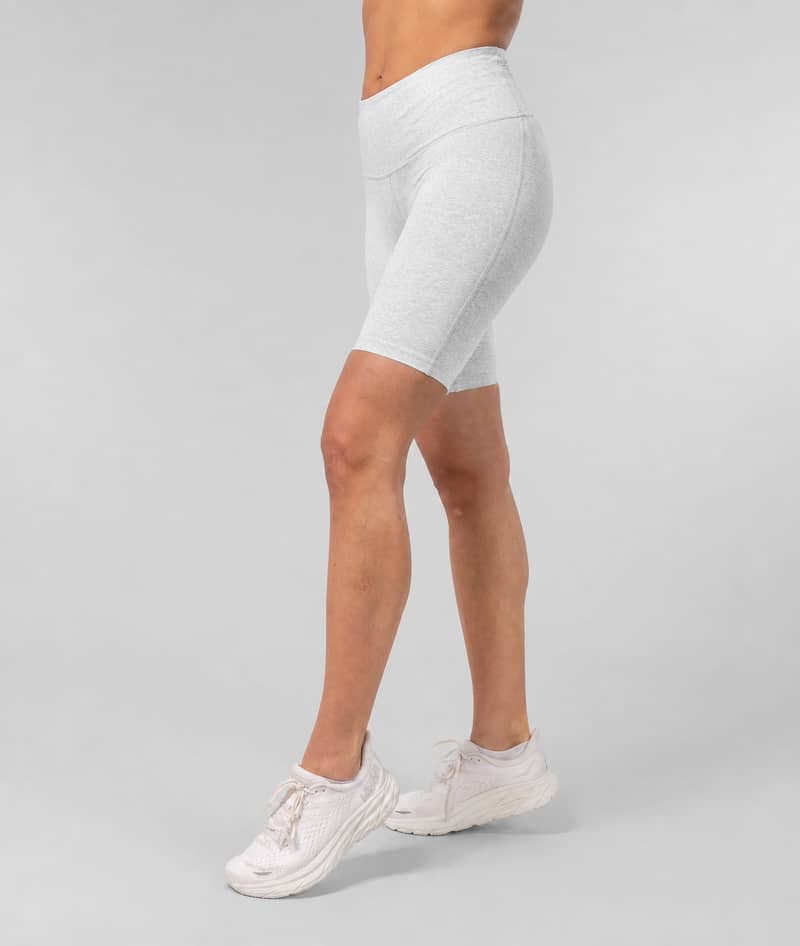Woman wearing gray Johaug cycling shorts, side view from waist down, against a light gray background