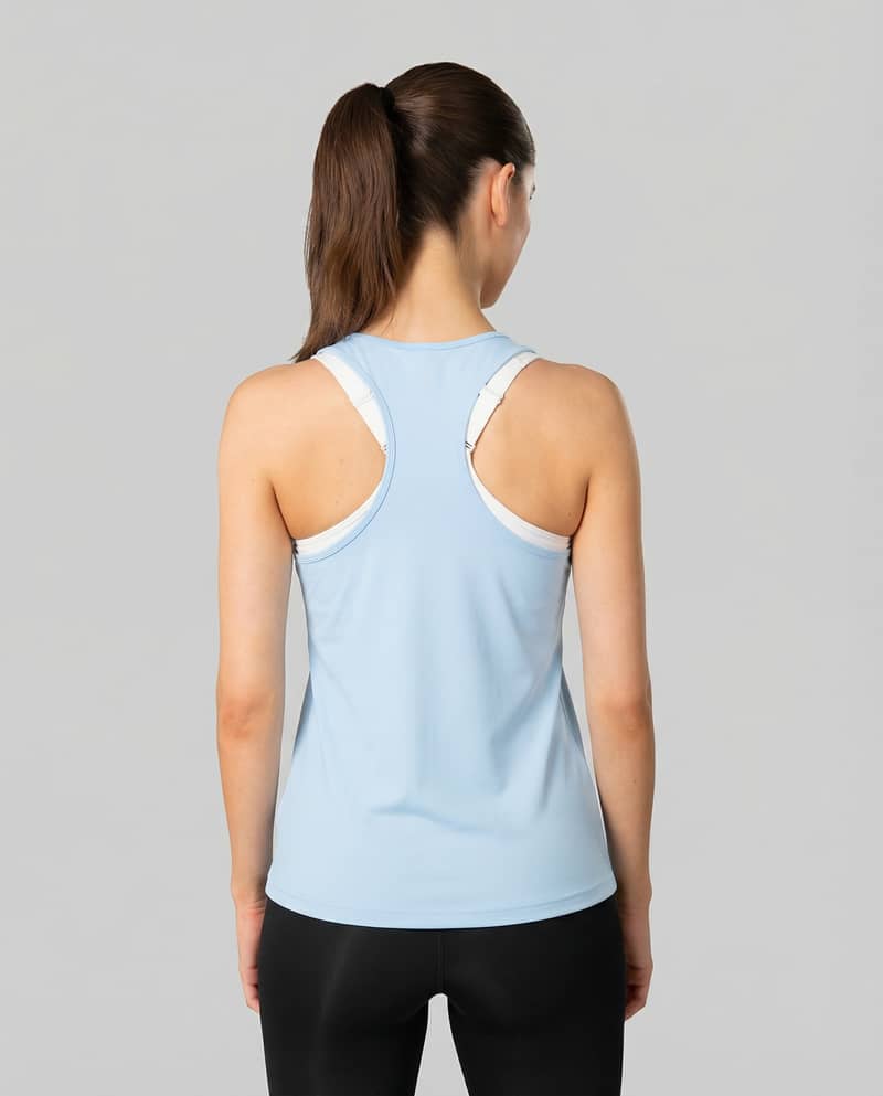 Back view of a woman wearing the light blue Johaug Energy Singlet, highlighting the flexible racerback design.