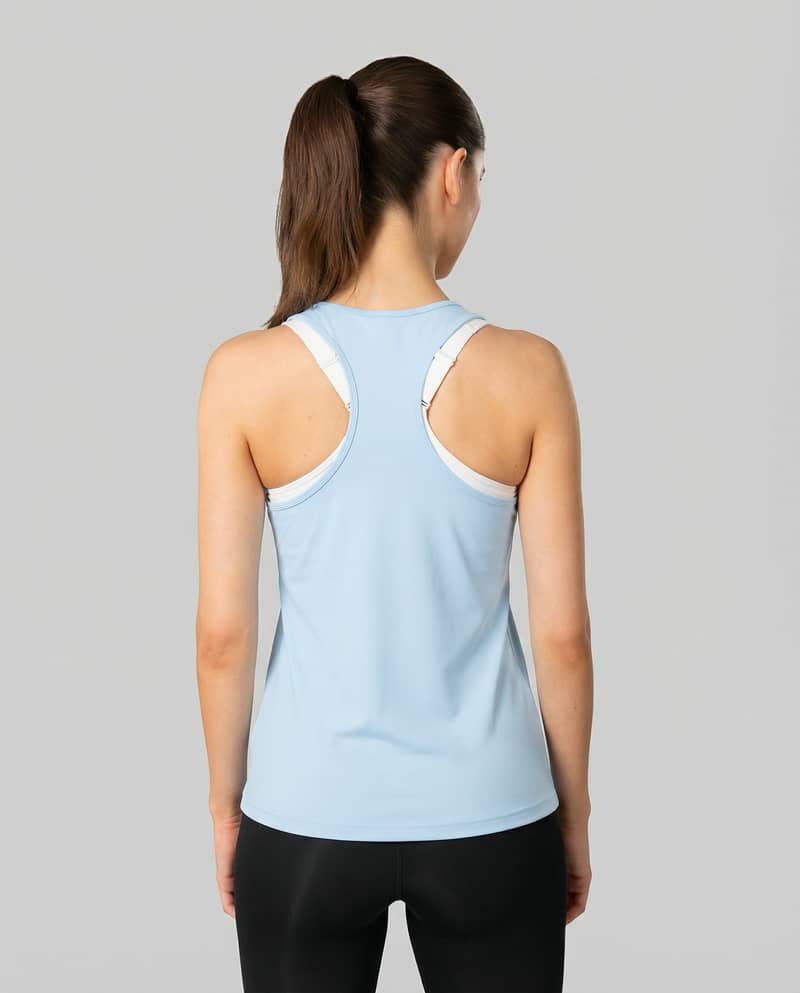 Back view of a woman wearing the light blue Johaug Energy Singlet, highlighting the flexible racerback design.