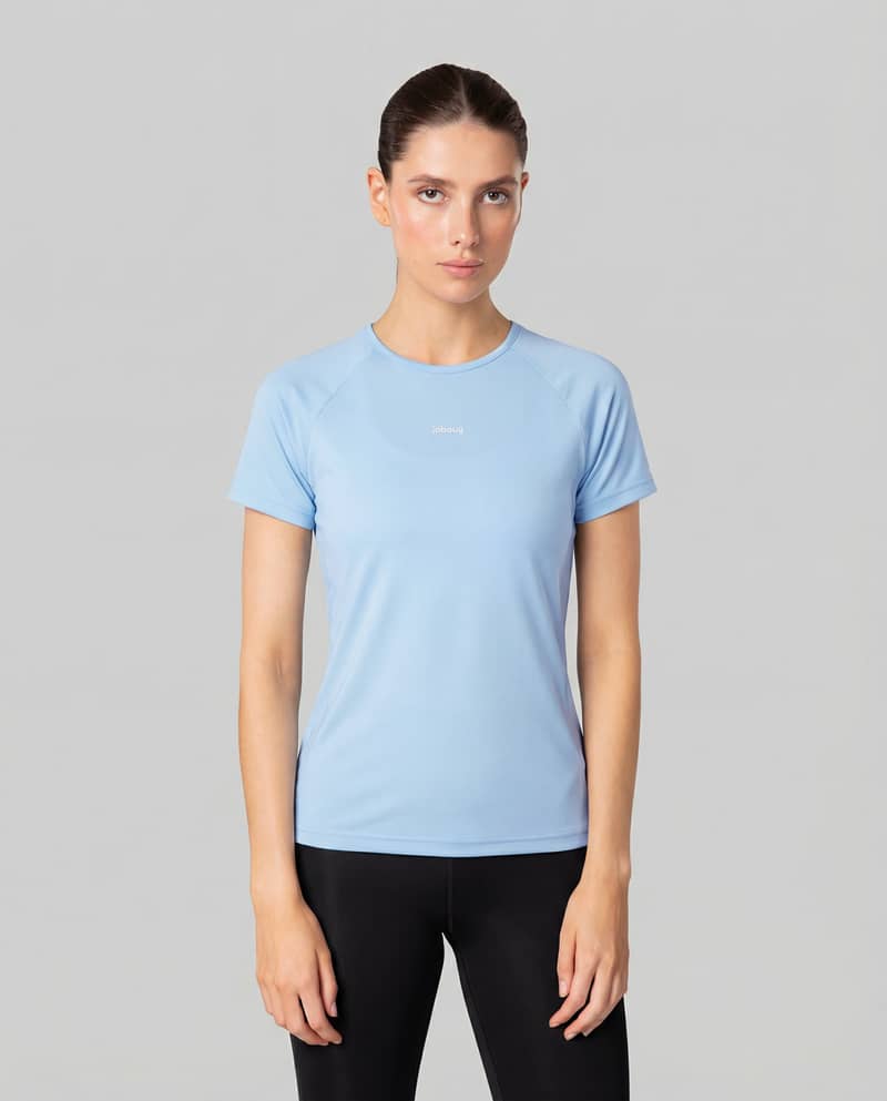 Woman wearing the light blue Johaug Energy T-Shirt, a lightweight training tee perfect for running or gym workouts.