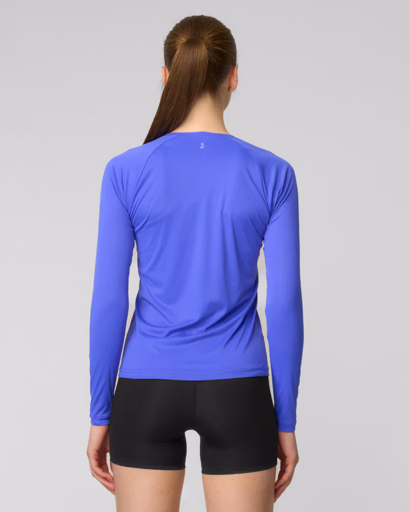 Back view of a woman wearing a periwinkle blue long-sleeve running top