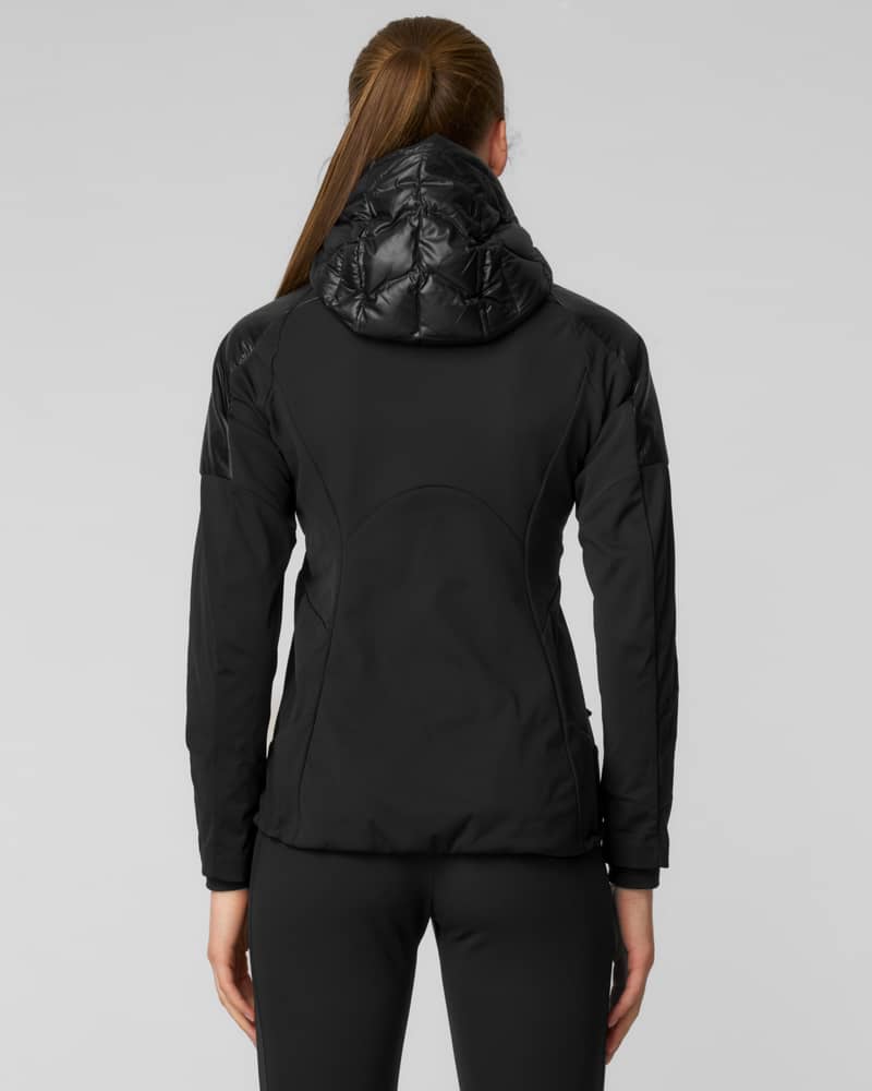 Woman wearing a glossy black puffer jacket with hood and black beanie, side profile