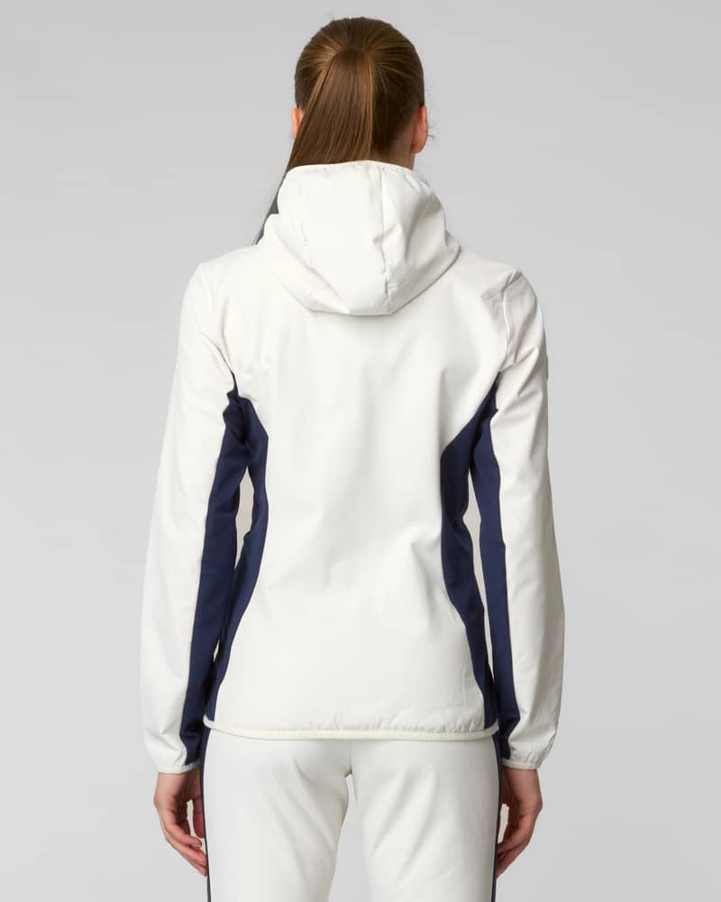 Back view of a woman wearing a white hooded jacket with navy side panels