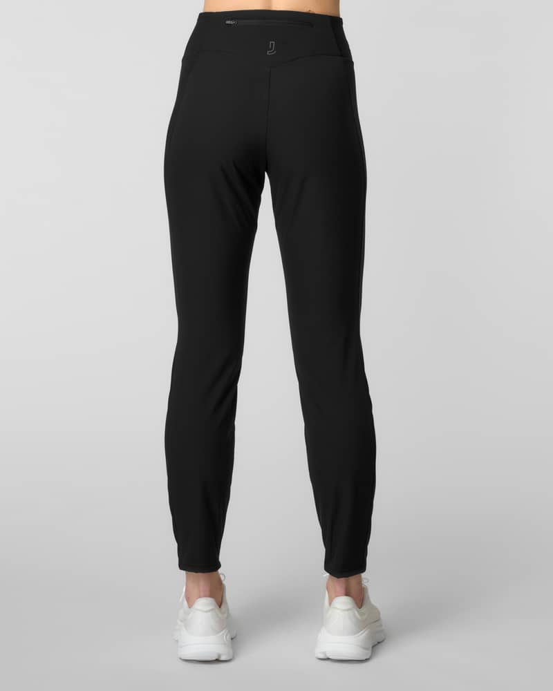Back view of black slim-fit joggers with a hidden zip pocket at the waistband