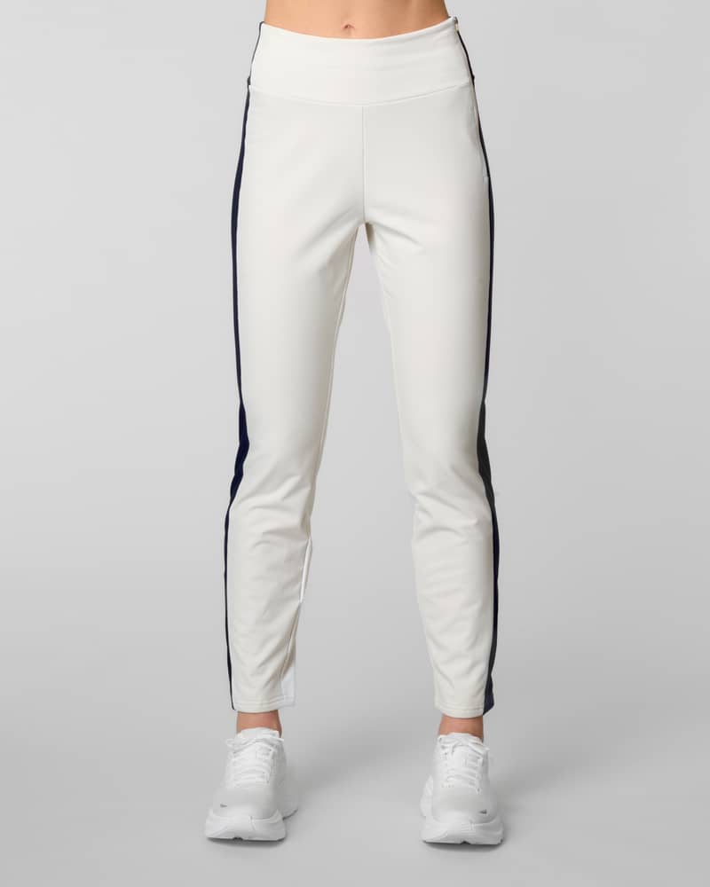 Front view of ivory ski pants with a navy side stripe