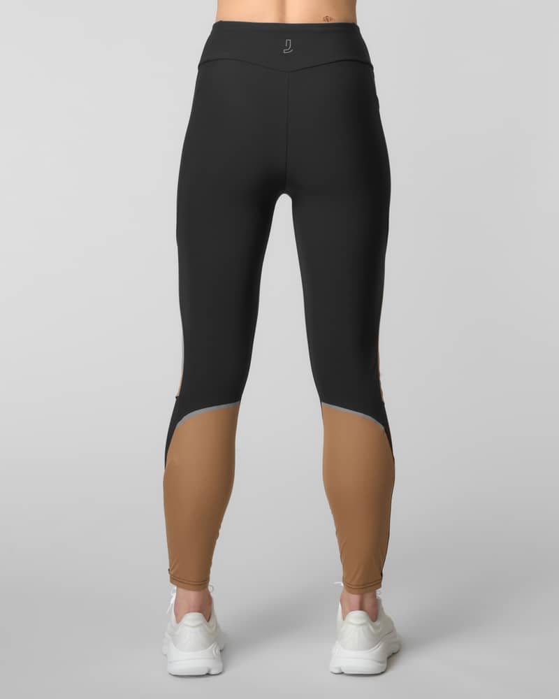 Back view of black and camel color-blocked running leggings