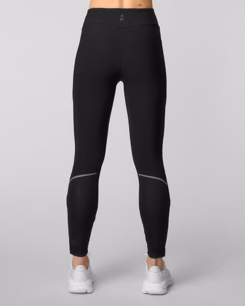 Back view of black running leggings with reflective knee stripes